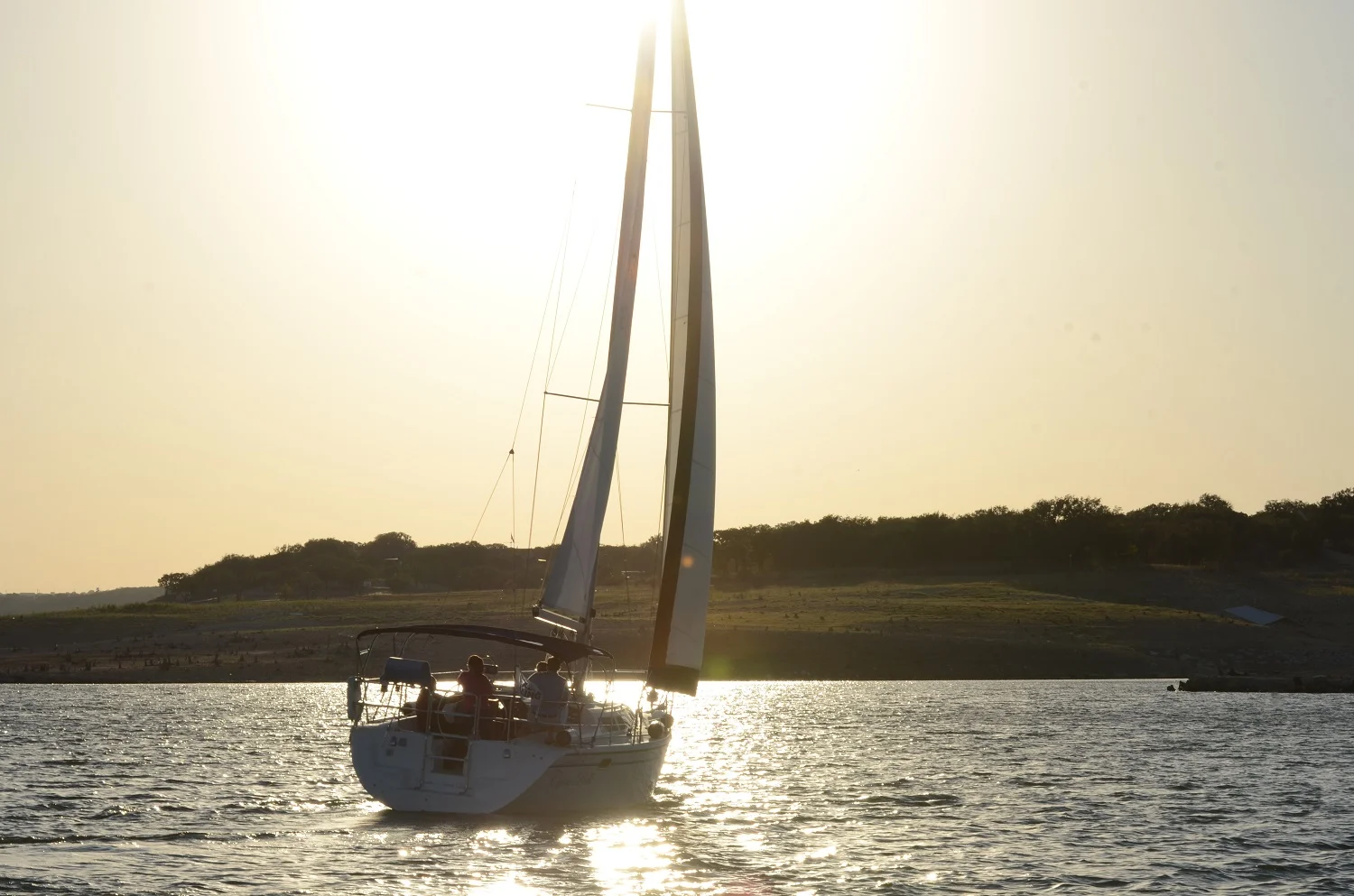 Sailboat silhouetted against the sunset on Lake Travis